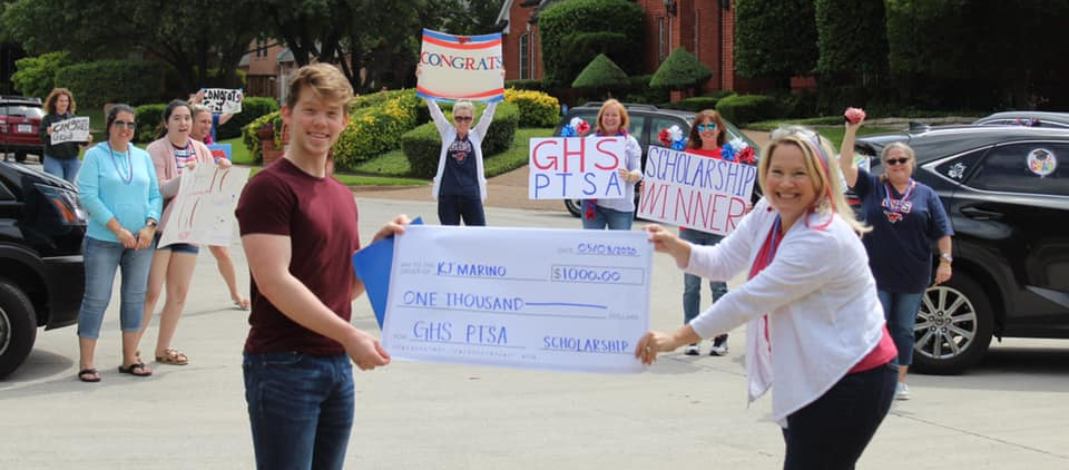 A GHS student receives a scholarship from PTSA